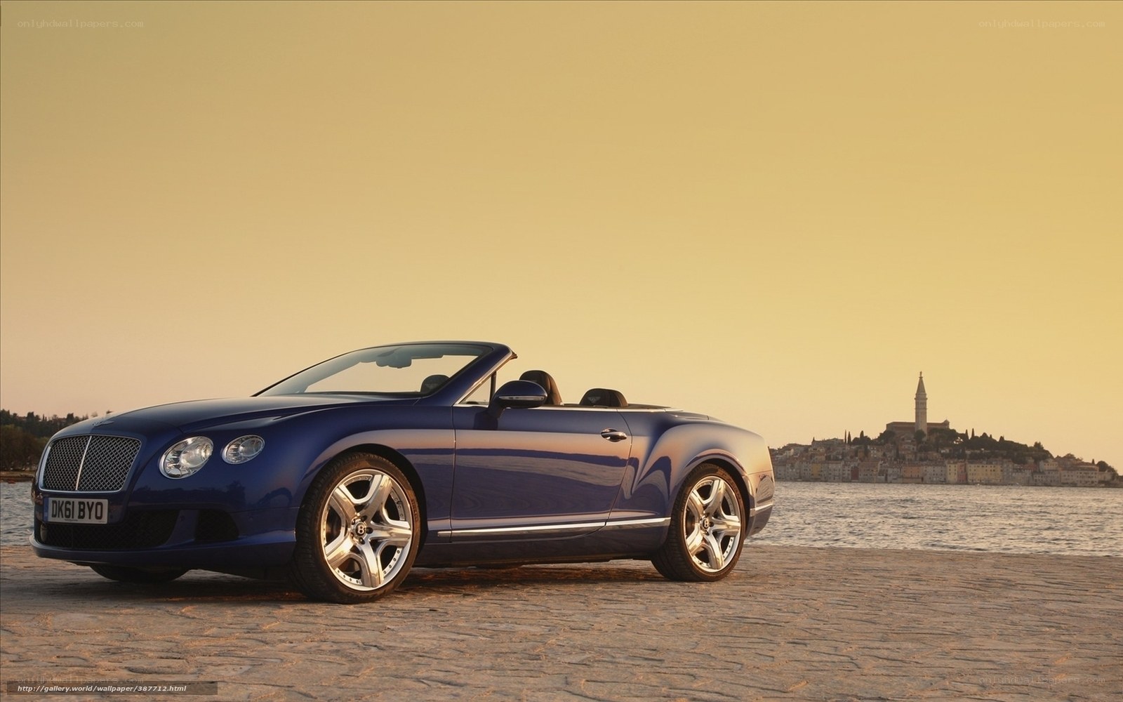 Blue Bentley convertible by the sea