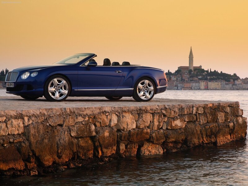 Blue Bentley convertible by the sea