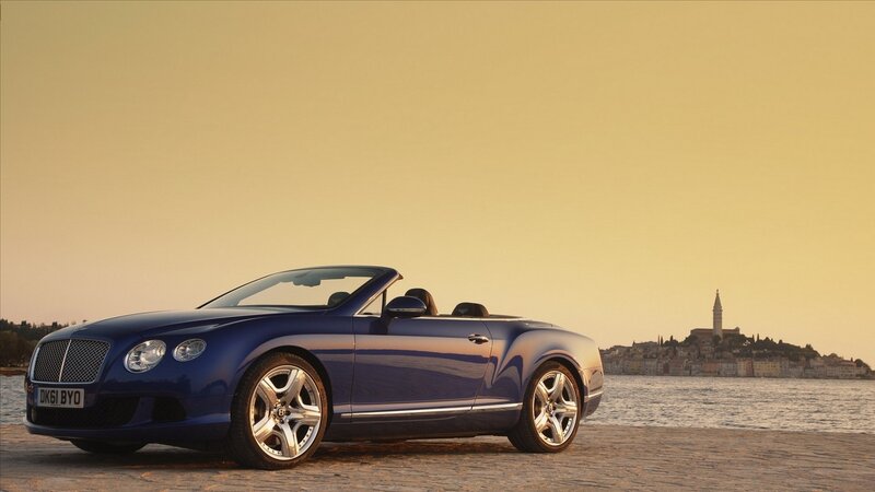 Blue Bentley convertible by the sea