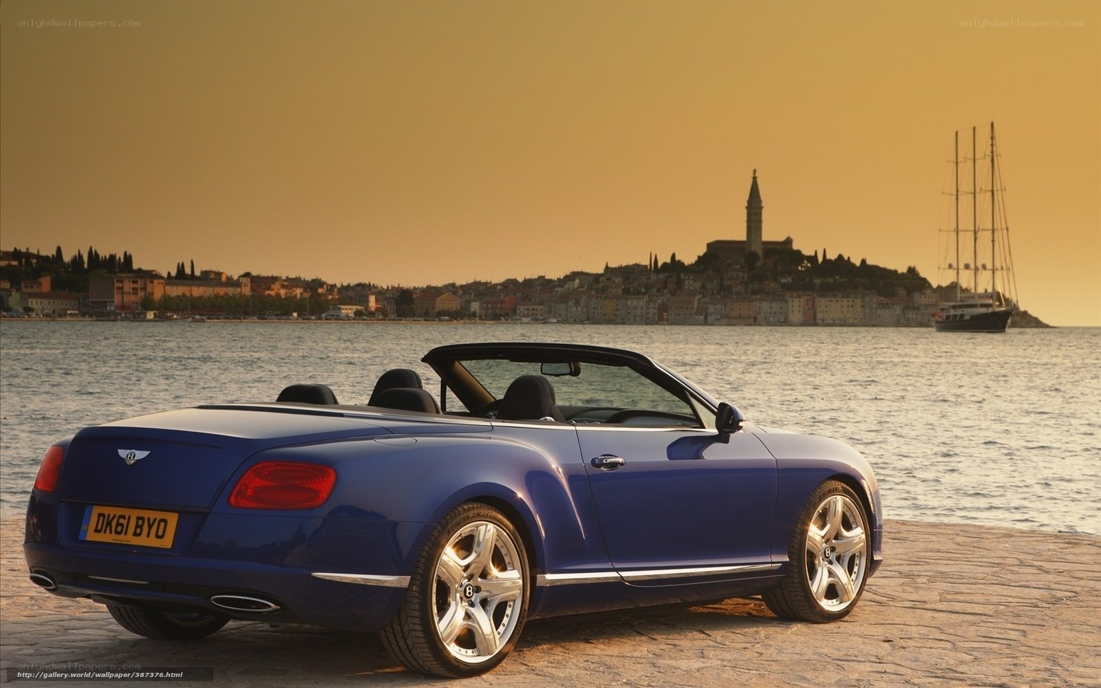 Blue Bentley convertible by the sea