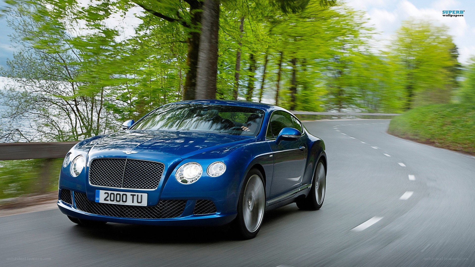 blue bentley driving on road