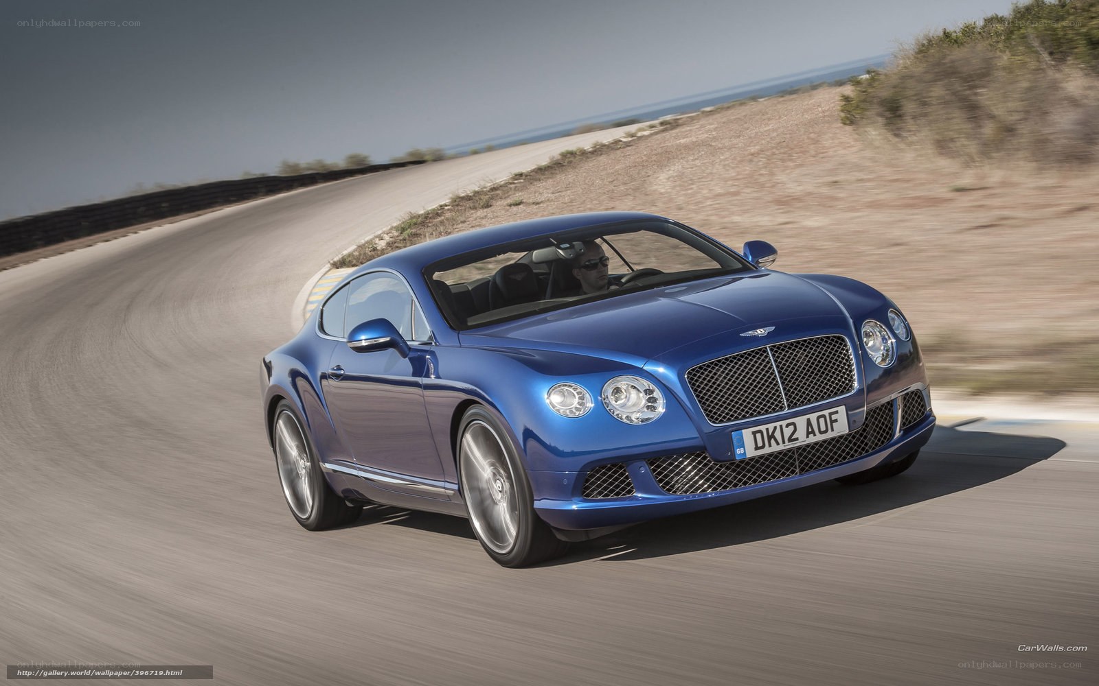blue bentley driving on road