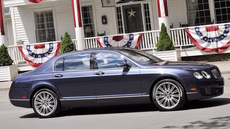 Blue Bentley on a patriotic street