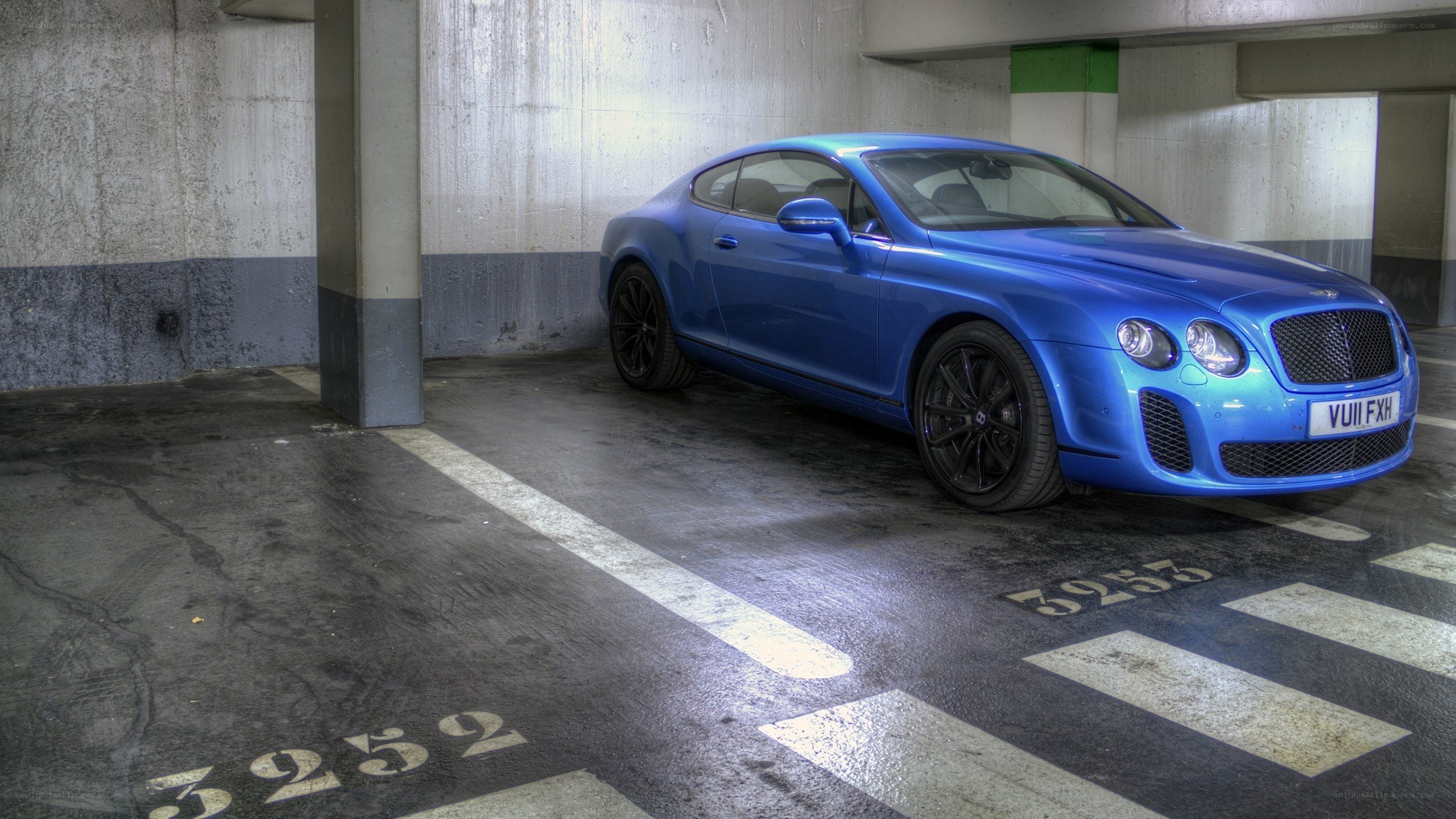 Blue Bentley parked in garage