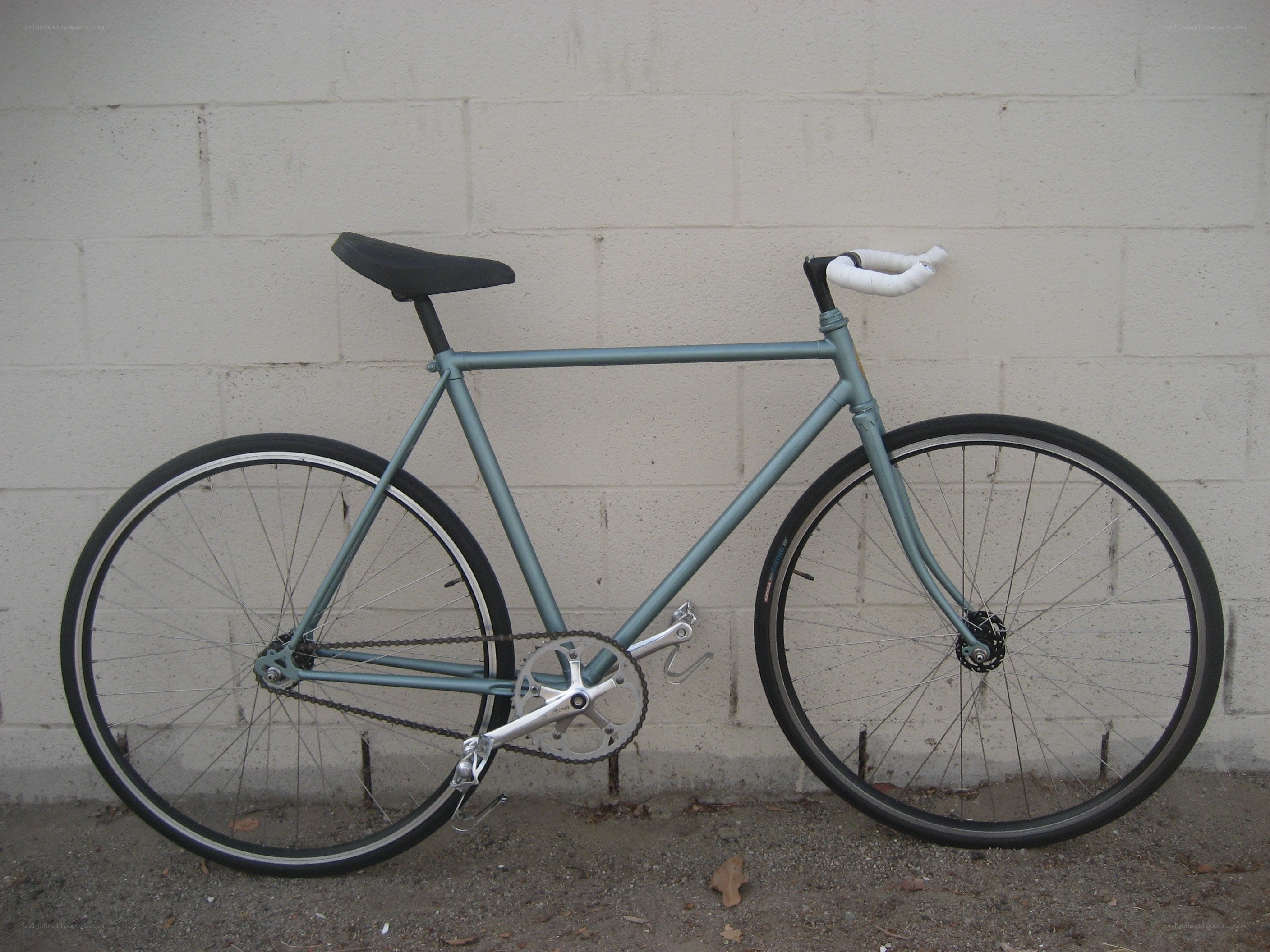 blue bicycle against wall