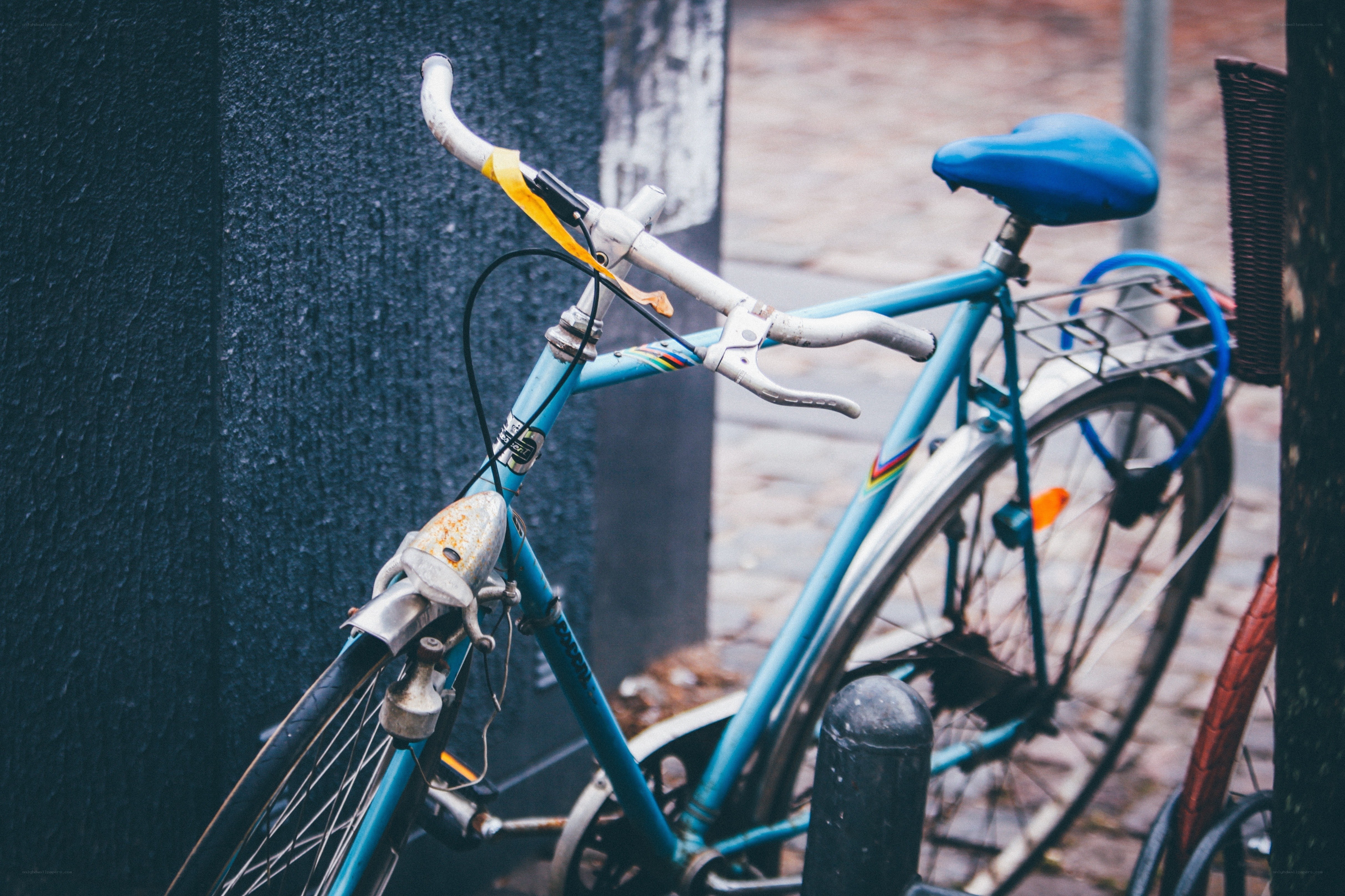 blue bicycle on cobblestone street