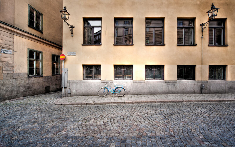 Blue Bicycle on Sidewalk — Beige