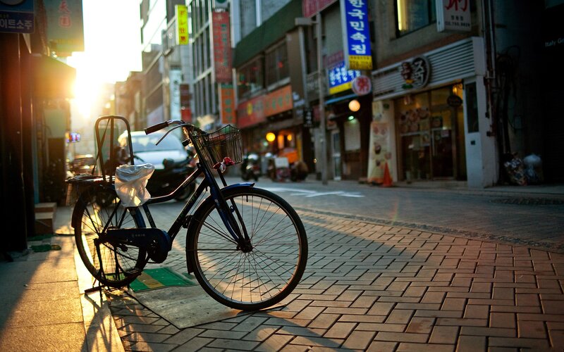Blue Bicycle on Sidewalk — Brown