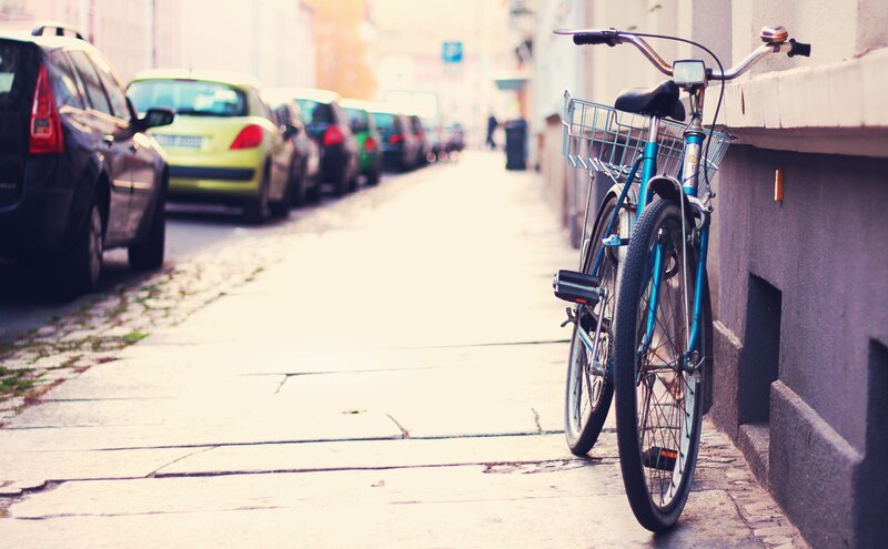 Blue Bicycle on Sidewalk — Calm, Afternoon, Photograph, Cars
