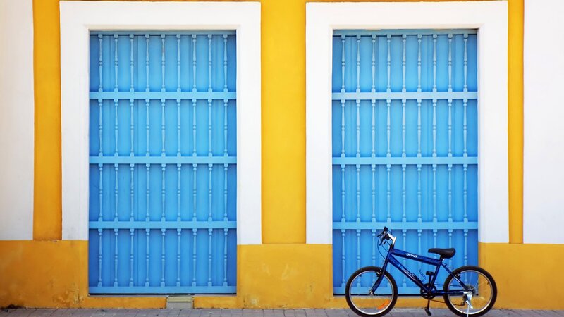 blue bike by blue doors