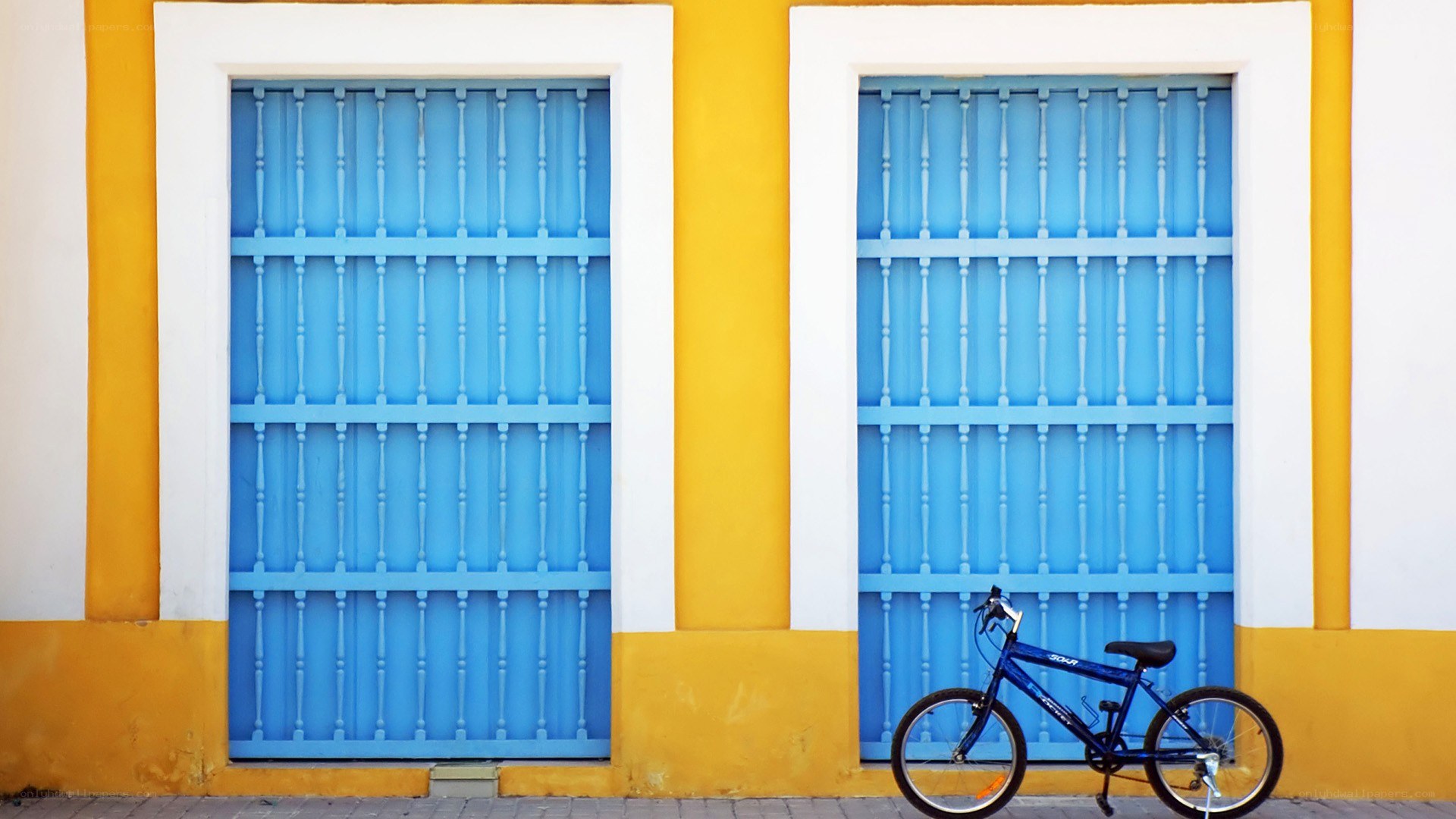 blue bike by blue doors