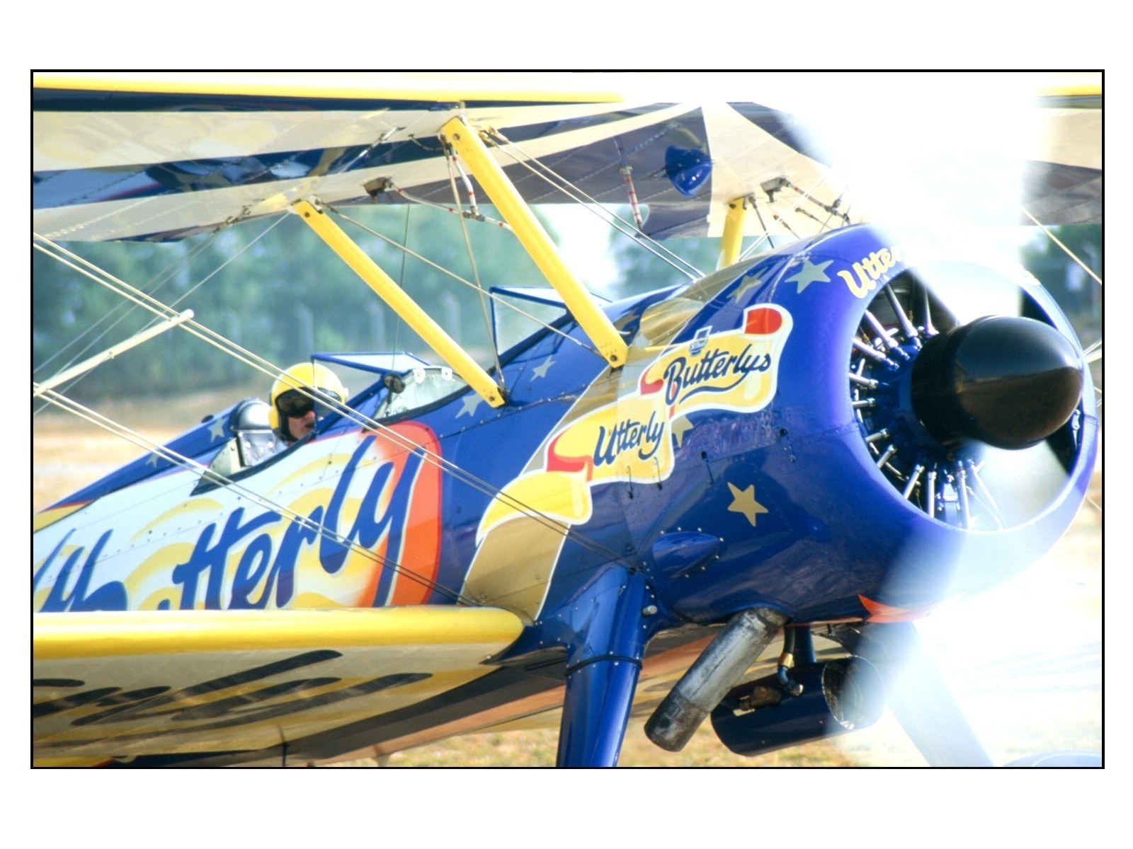 Blue biplane with pilot
