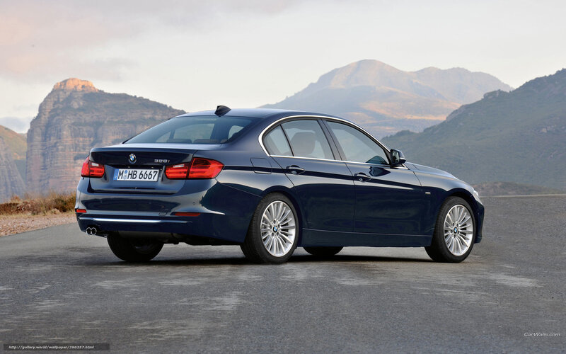 Blue BMW 328i on mountain road