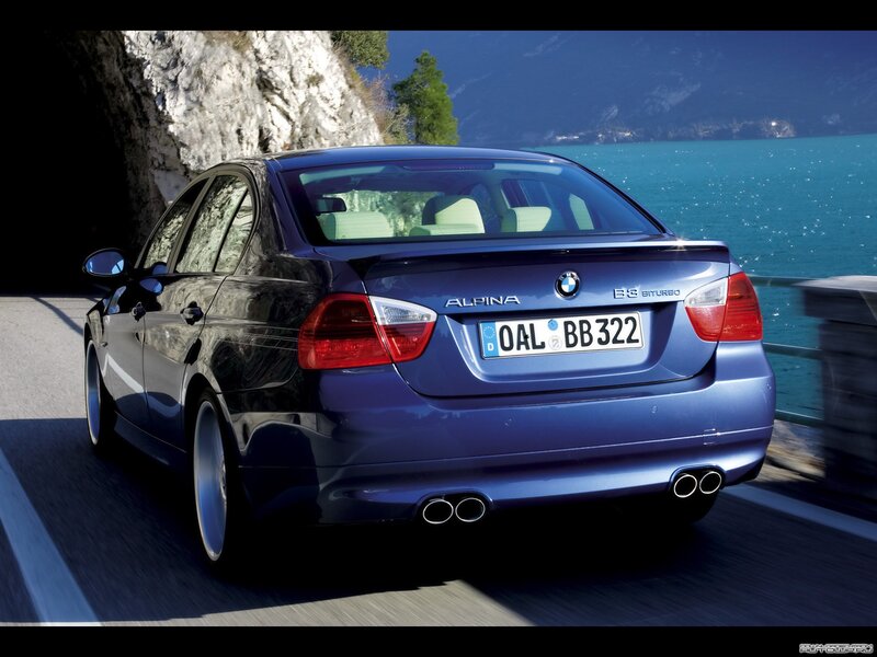 blue bmw alpina driving by lake