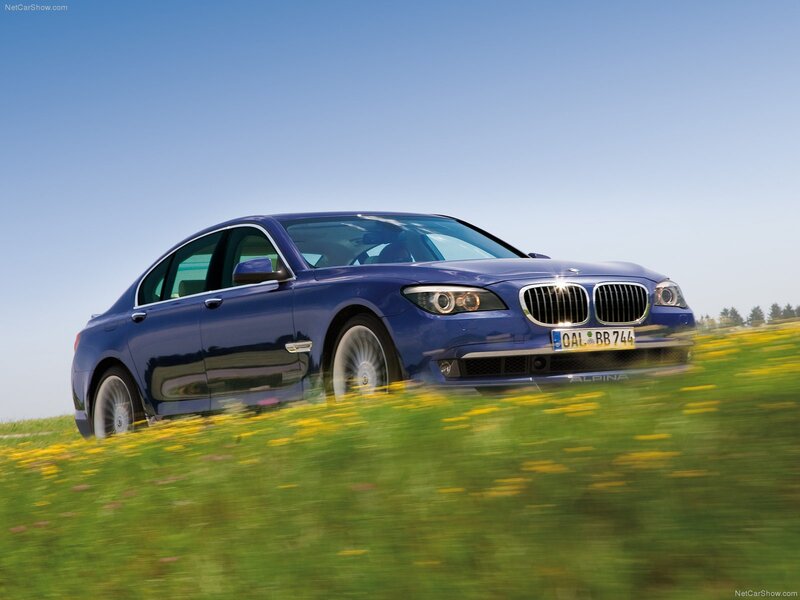 blue bmw alpina driving on field