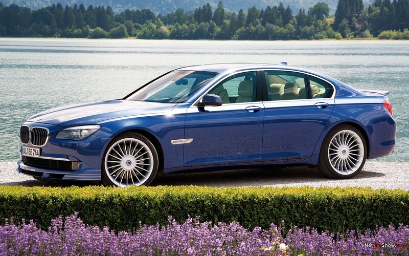 Blue BMW Alpina sedan by lake