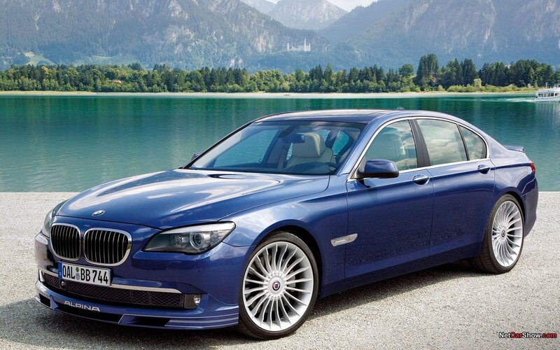 Blue BMW Alpina sedan by lake