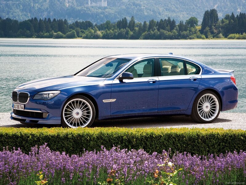 Blue BMW Alpina sedan by lake