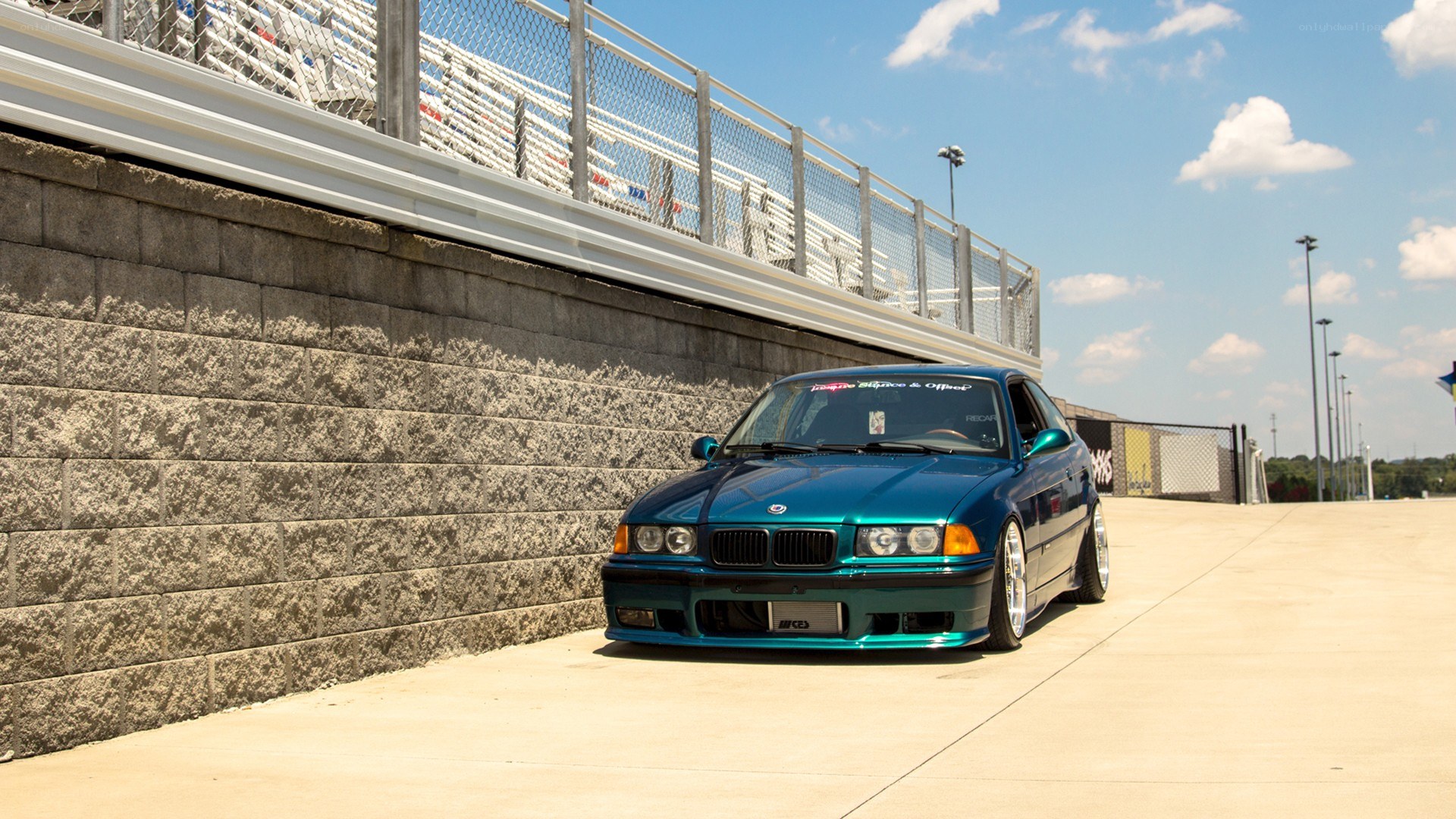 blue bmw at a racetrack