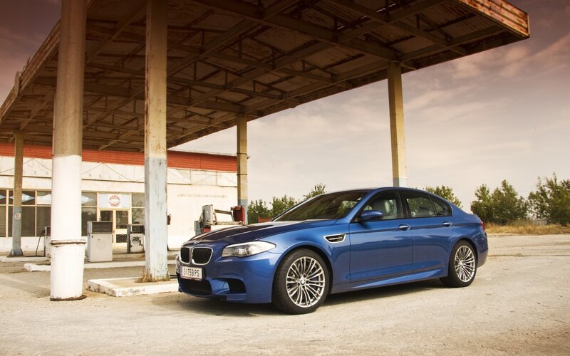 Blue BMW at old gas station