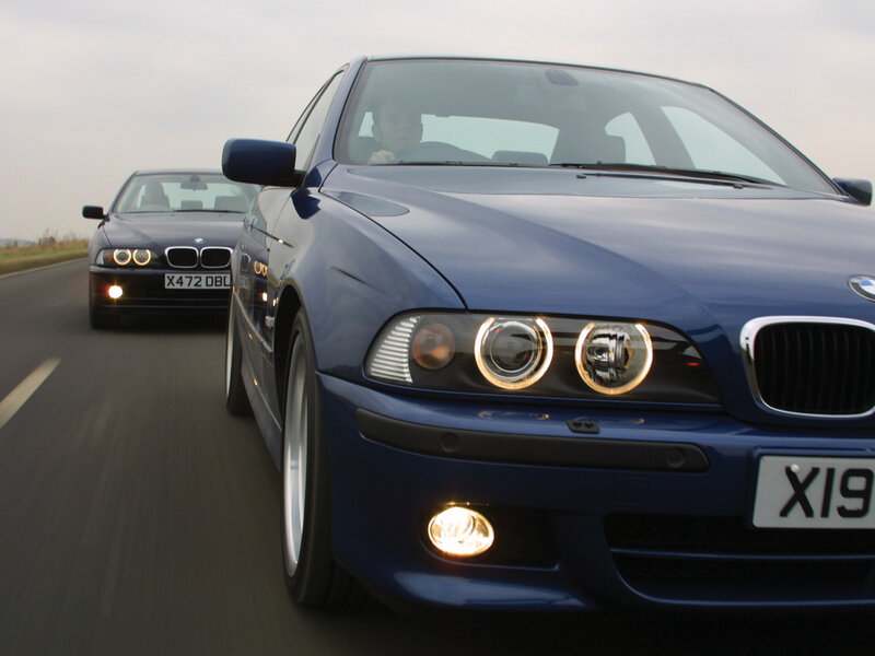 Blue BMW cars on a road