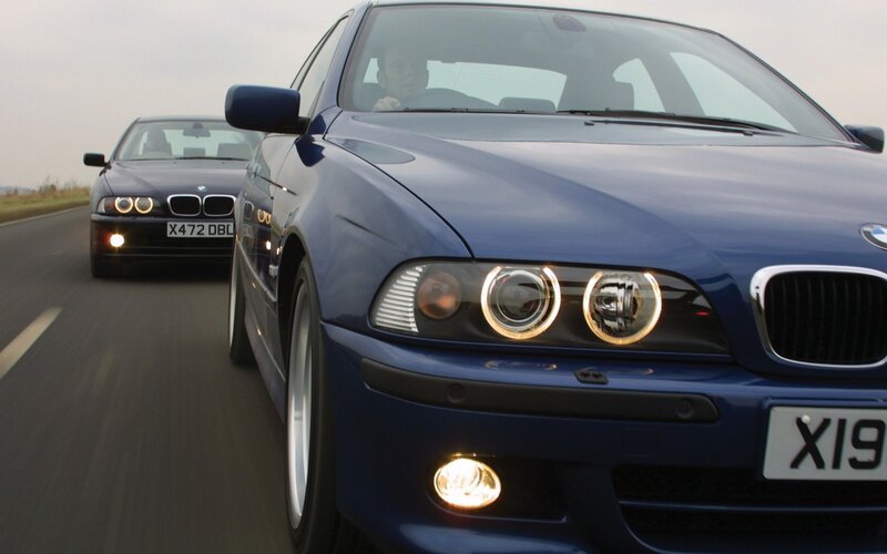 Blue BMW cars on a road