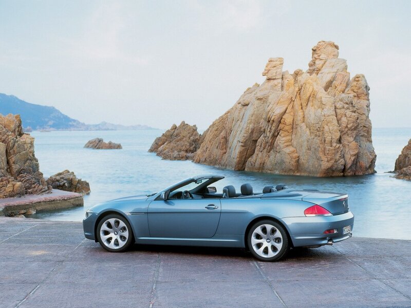 Blue BMW convertible by the sea