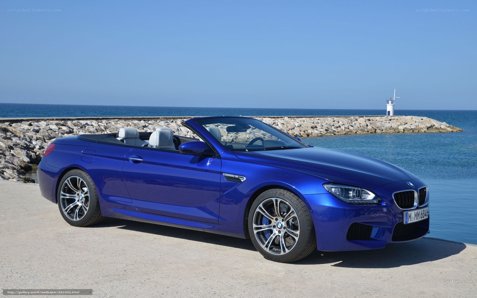 Blue BMW convertible by the sea