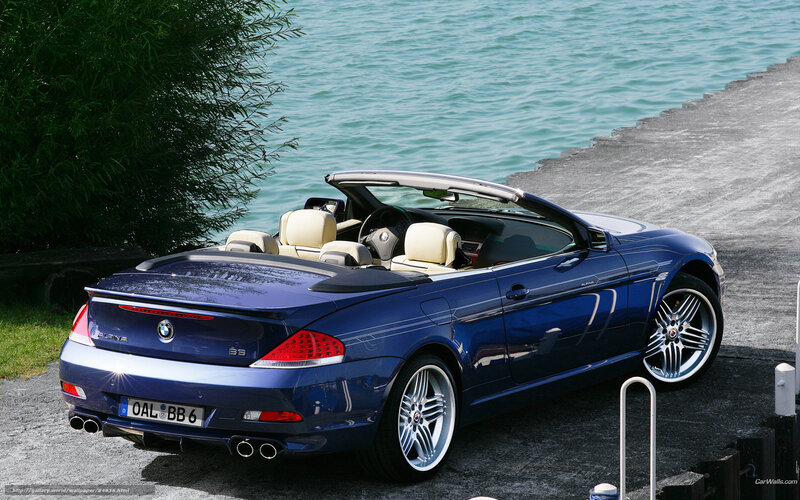 blue bmw convertible by water