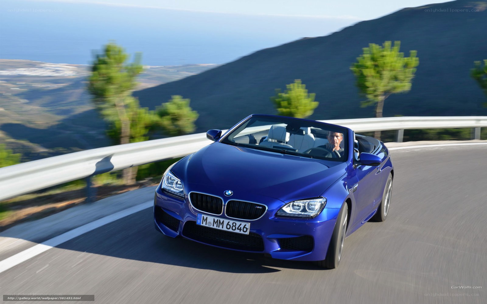 blue bmw convertible on coastal road