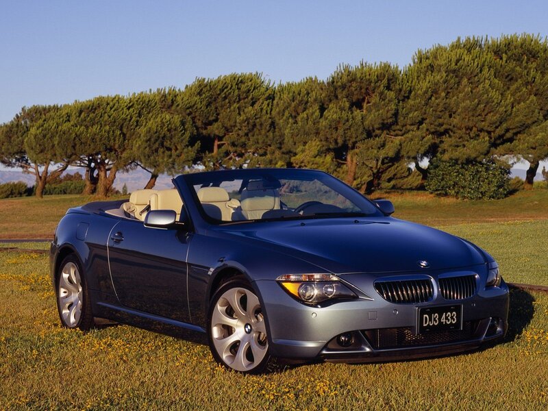 Blue BMW convertible on grass