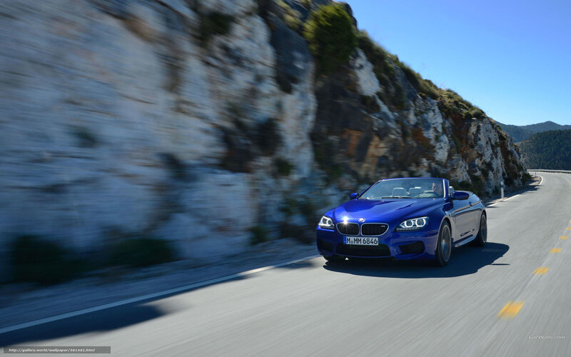 Blue BMW convertible on mountain road