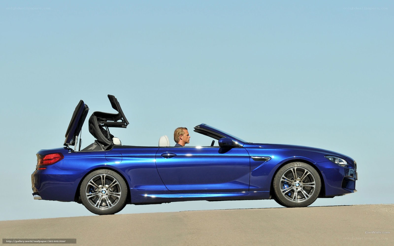 Blue BMW convertible on road