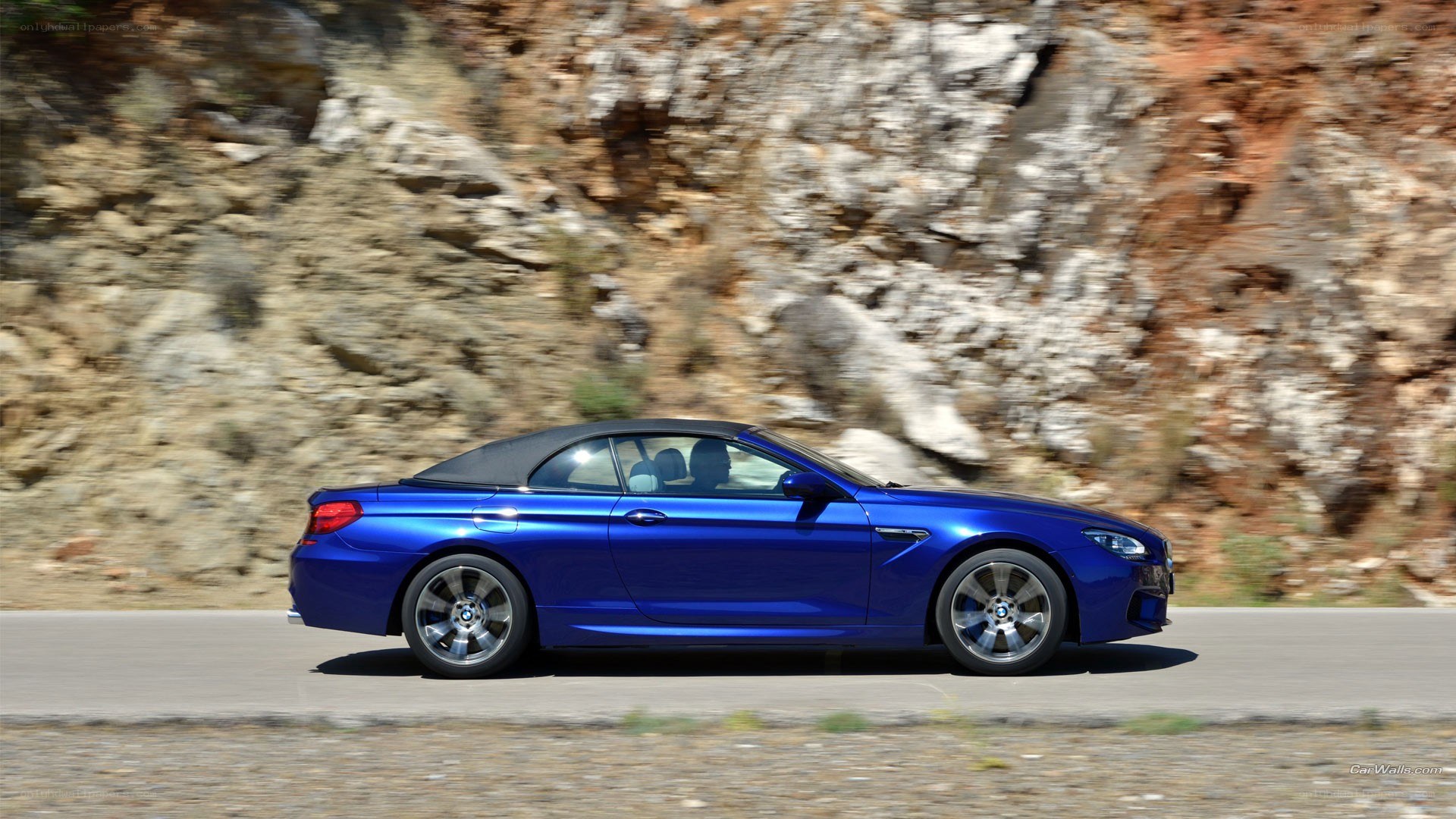 blue bmw convertible on road