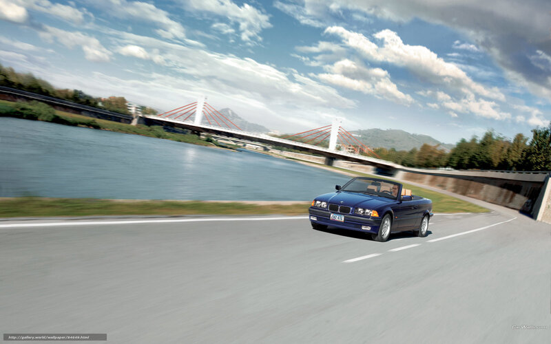 Blue BMW convertible on road