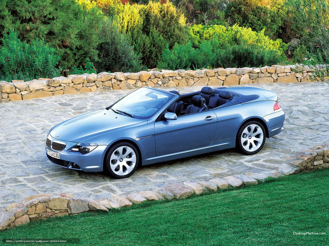 Blue BMW convertible on stone path