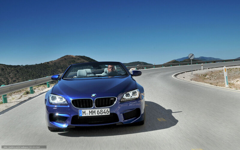 Blue BMW convertible on winding road