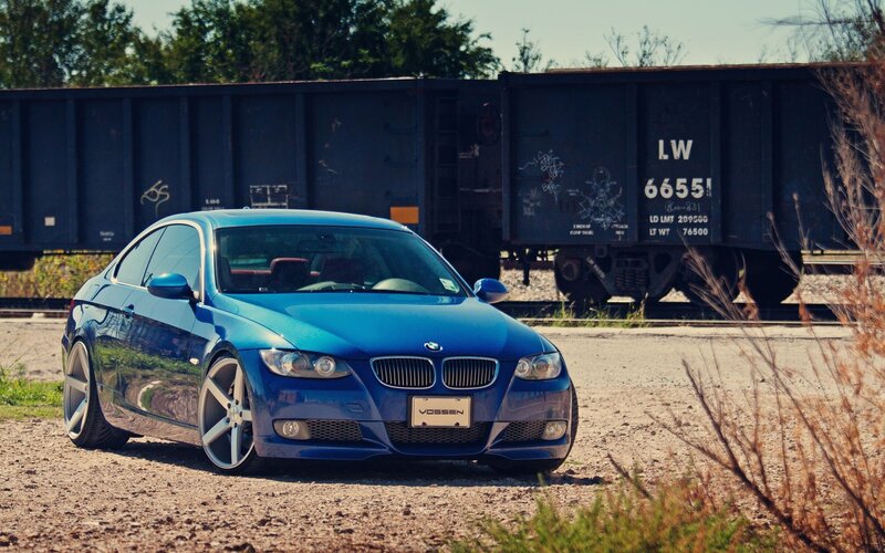 blue bmw coupe near train