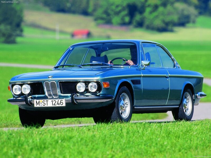 Blue BMW coupe on a country road