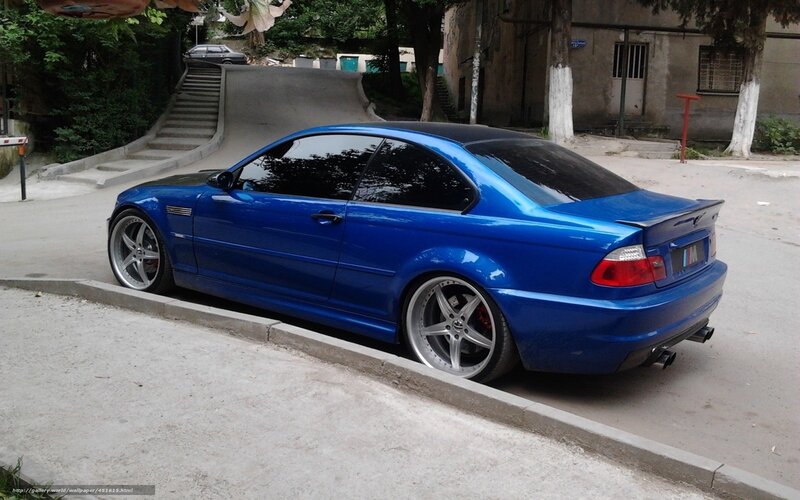blue bmw coupe parked on street