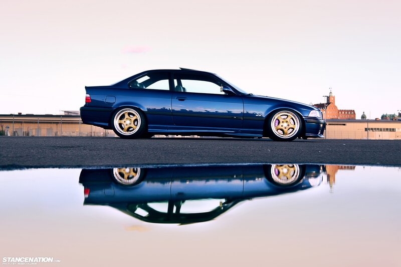 Blue BMW coupe with reflection