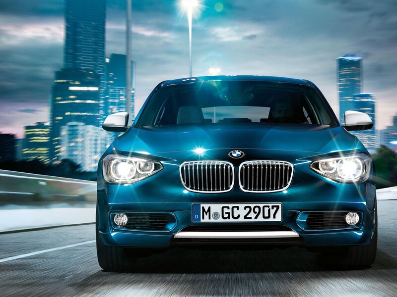 Blue BMW driving in city