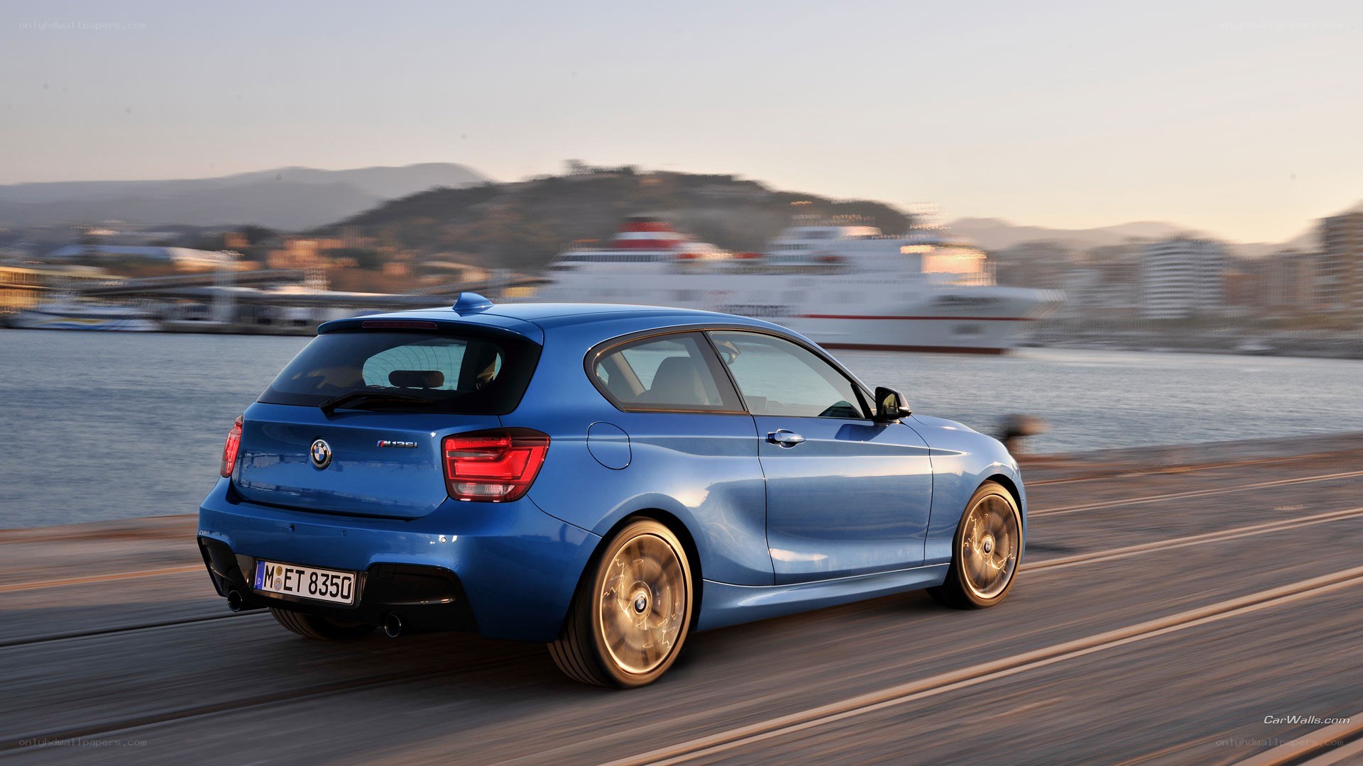 blue bmw driving on a pier