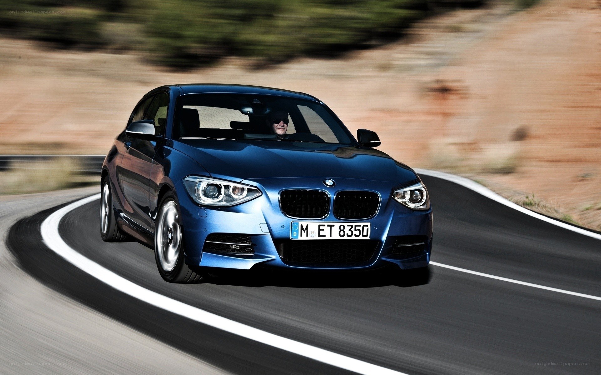 blue bmw driving on road