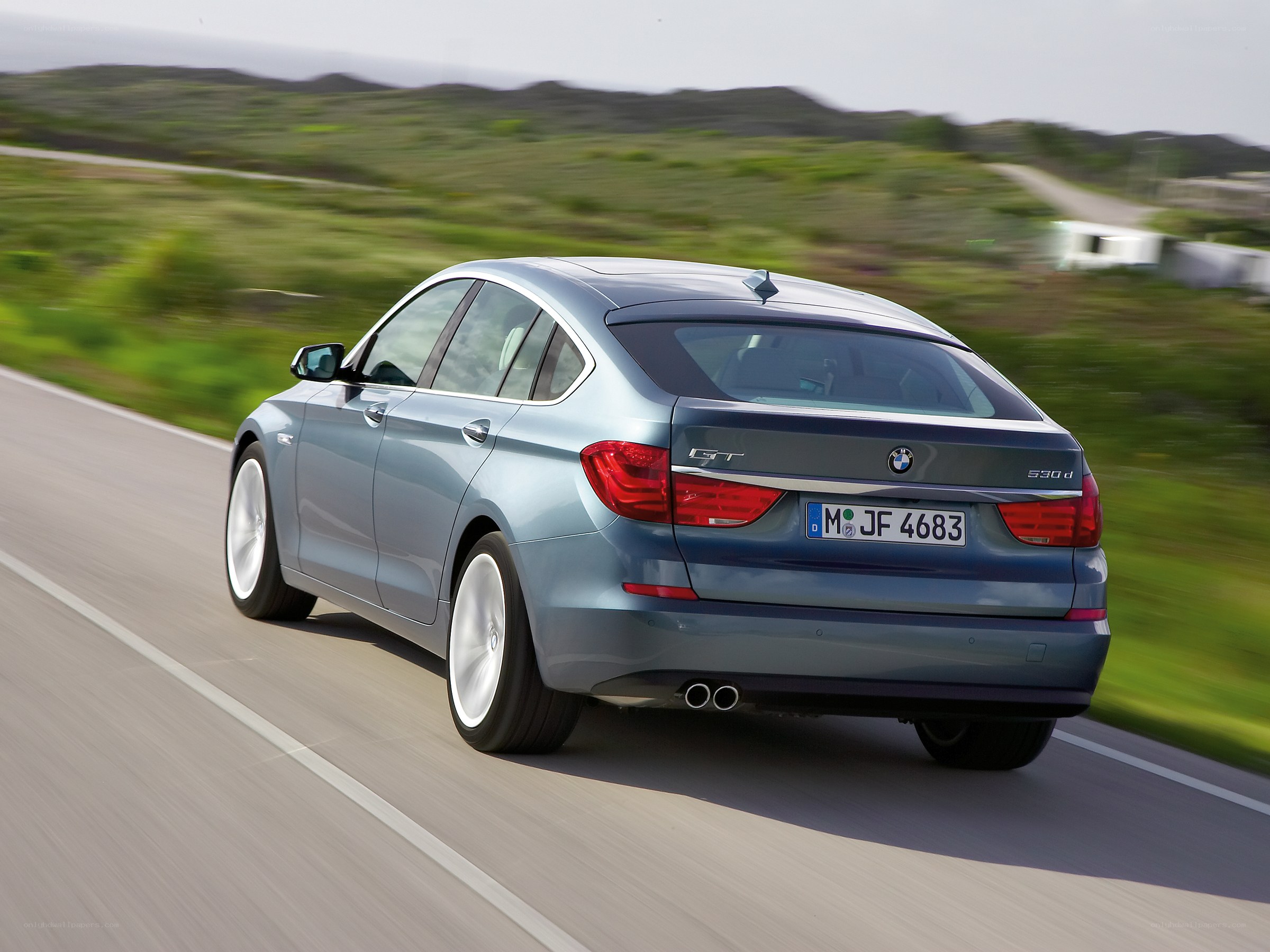 blue bmw driving on road