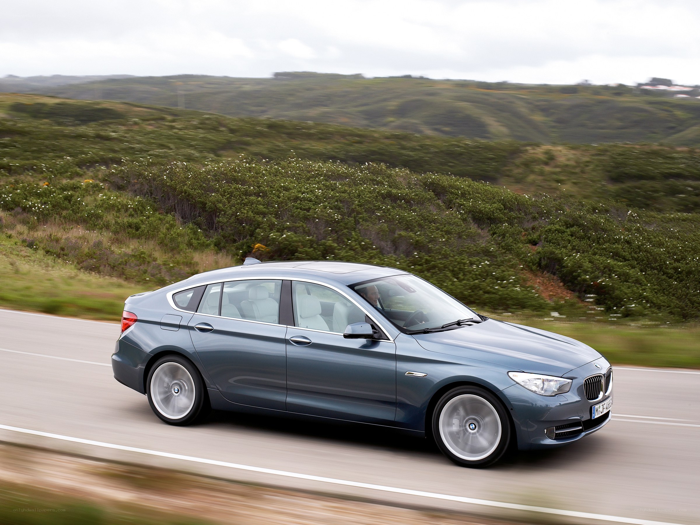 blue bmw driving on road
