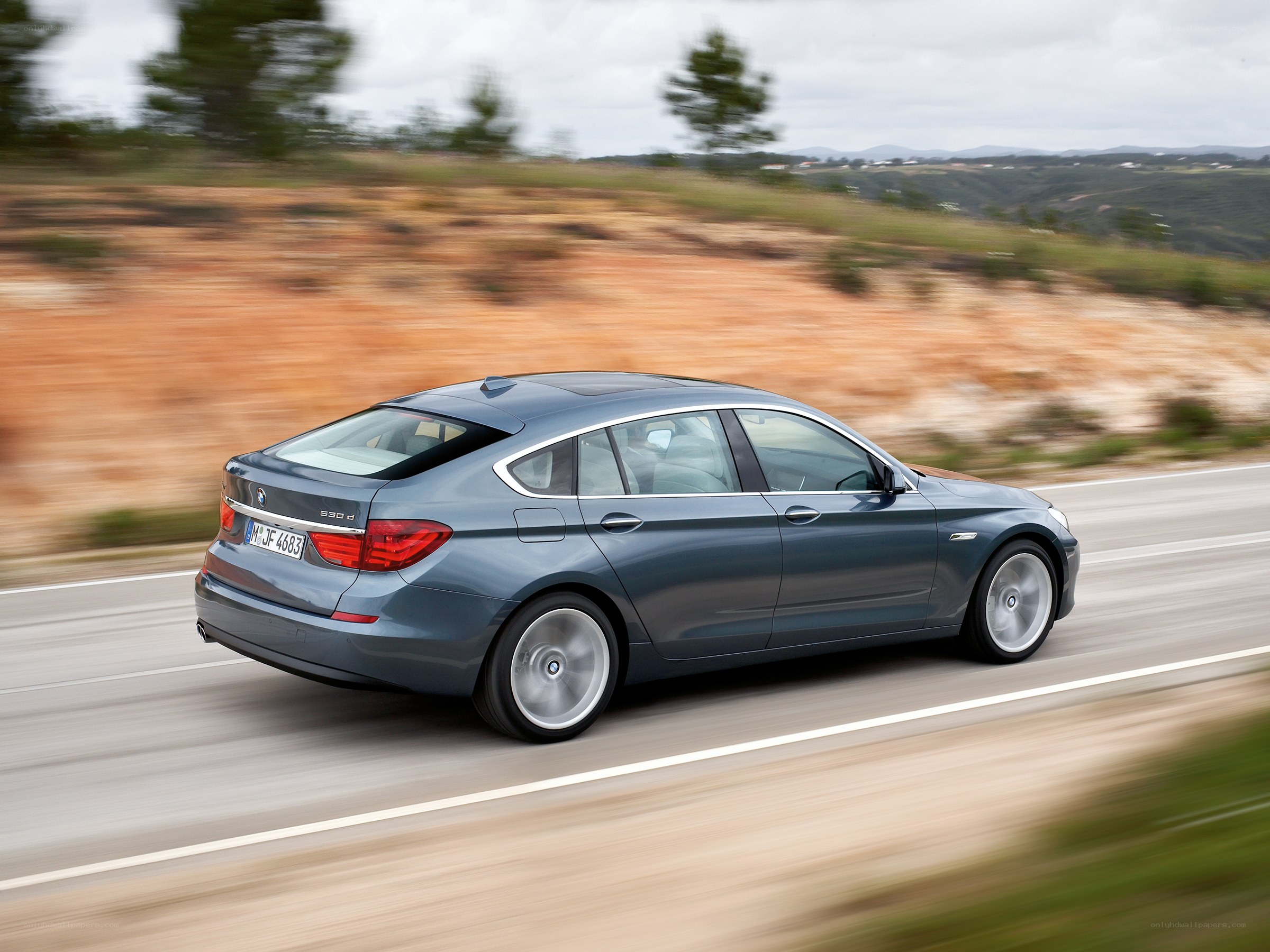 blue bmw driving on road
