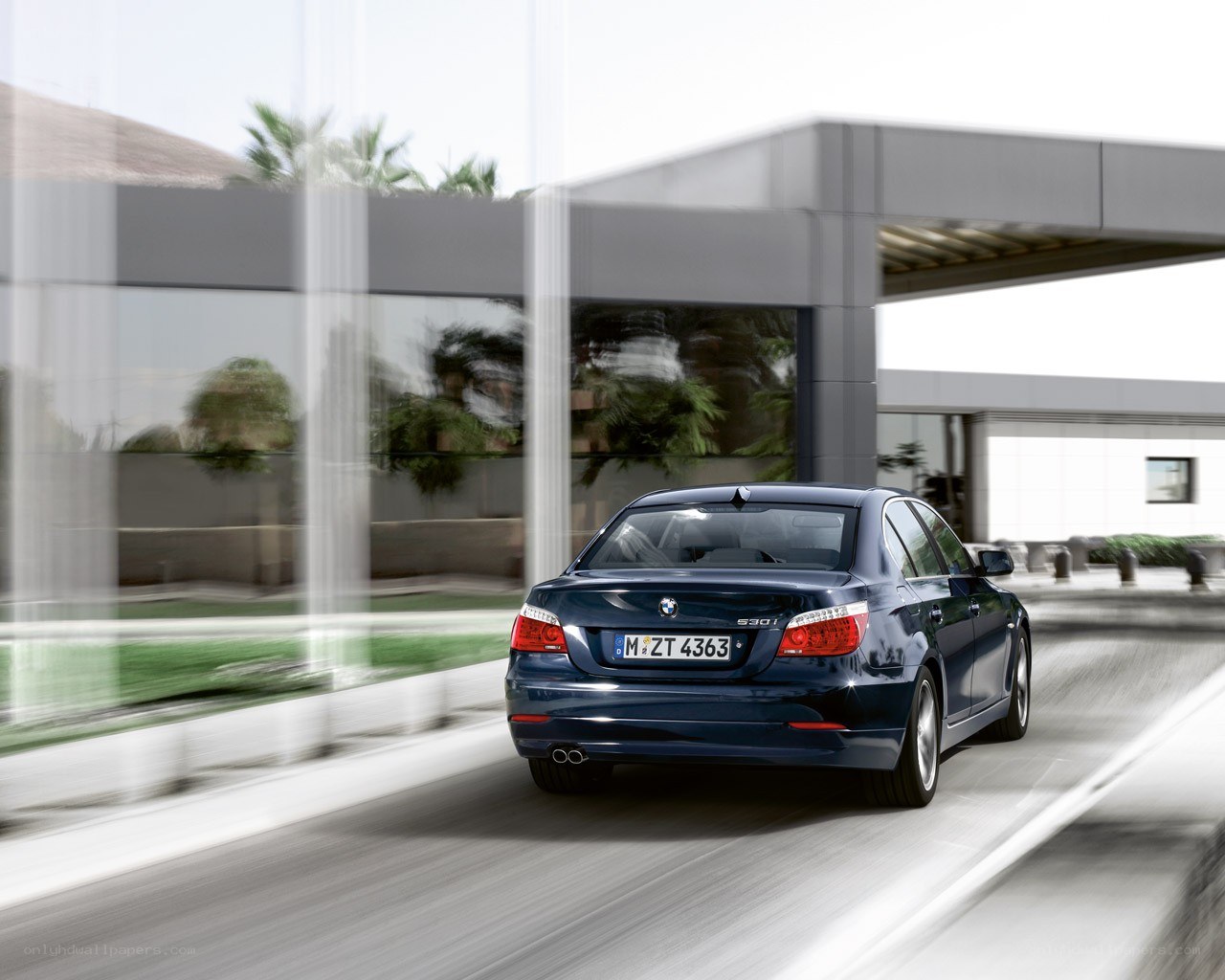 Blue BMW driving on road