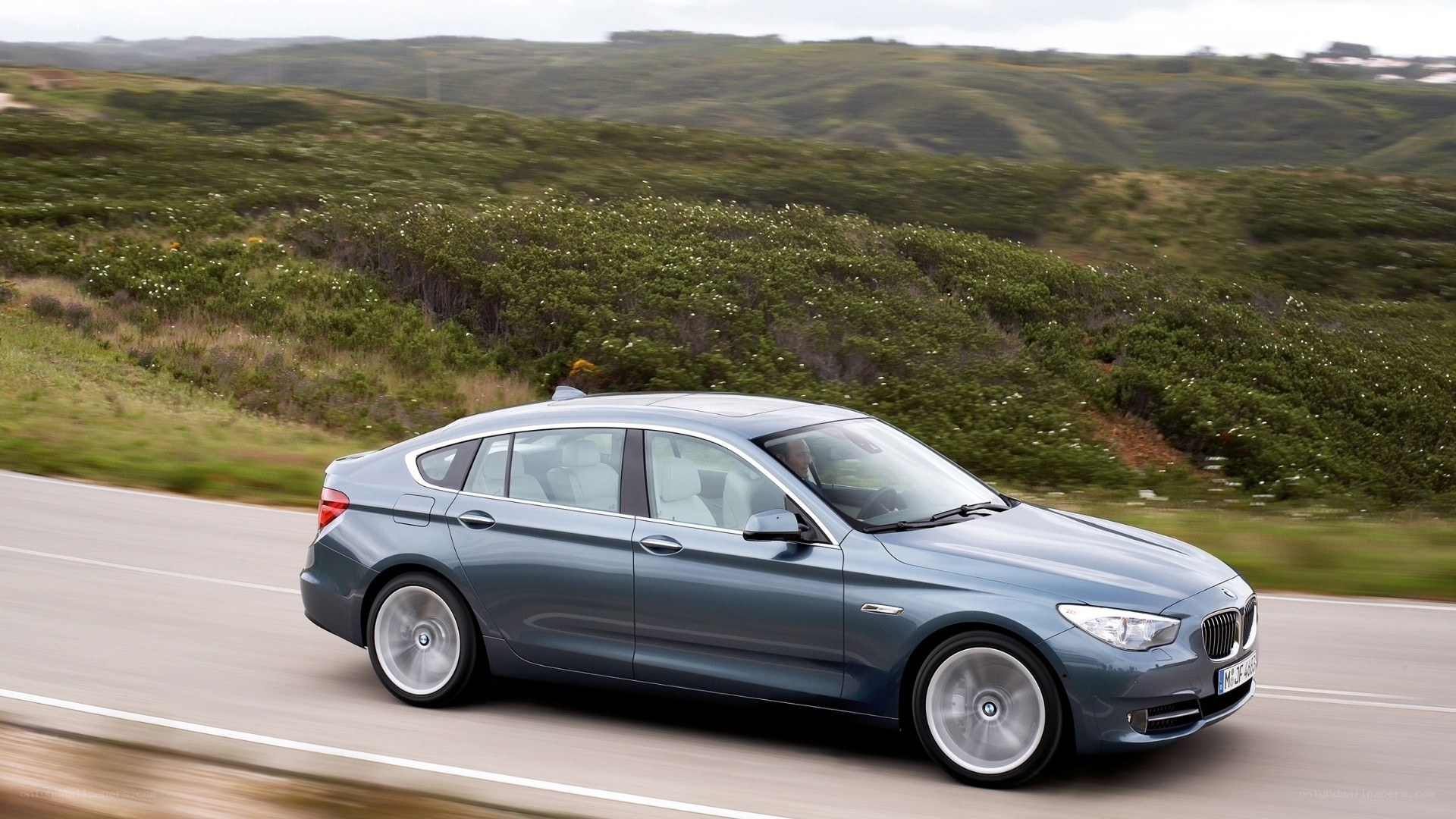 blue bmw driving on road