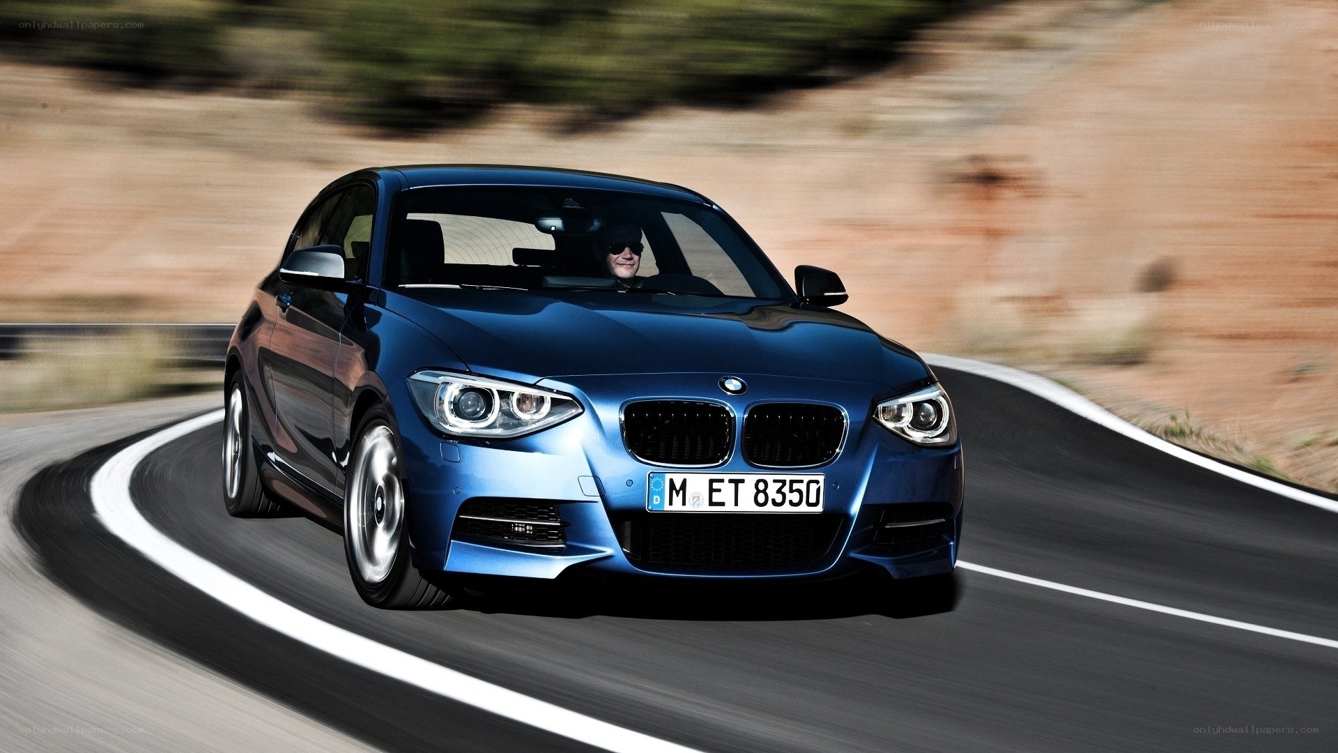 blue bmw driving on road